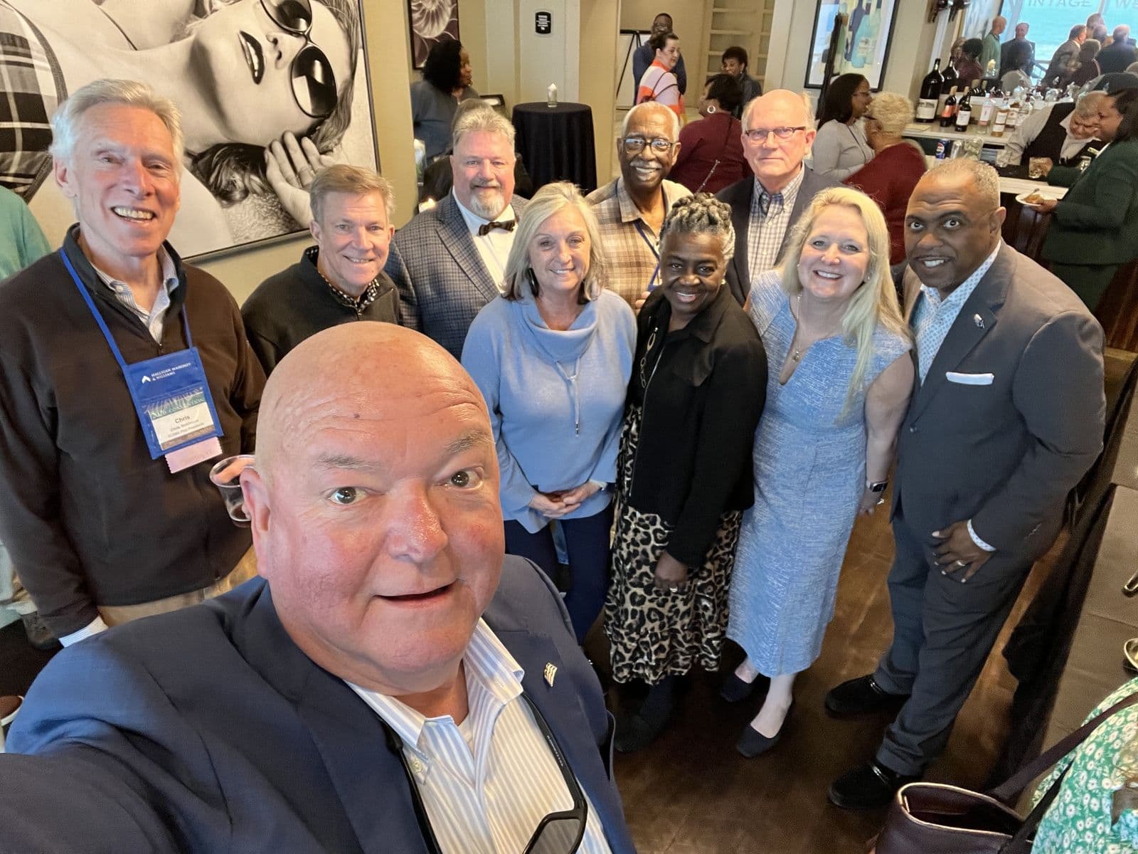Chuck Saylors with a group at an evening reception.
